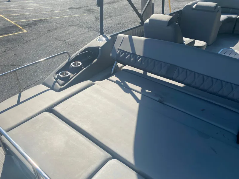 Slide: The Image of 2022 Bennington LX 24 Swingback boat interior with cushioned seating and cup holders. - 8