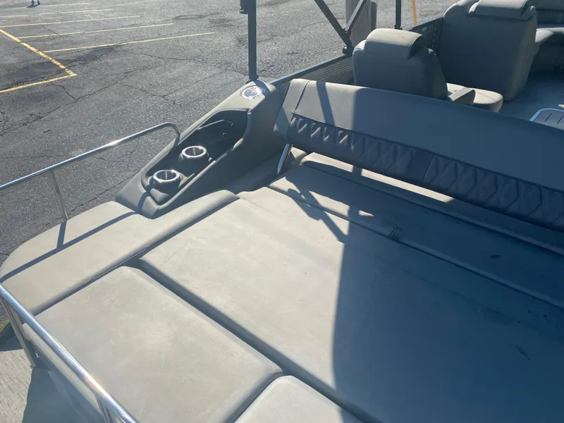 Slide: The Image of 2022 Bennington LX 24 Swingback boat interior with seating and cup holders. - 9