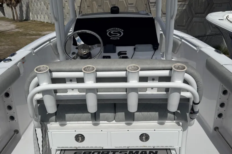 Slide: The Image of 2020 Sportsman Open 232 Center Console boat interior with rod holders and steering wheel. - 5
