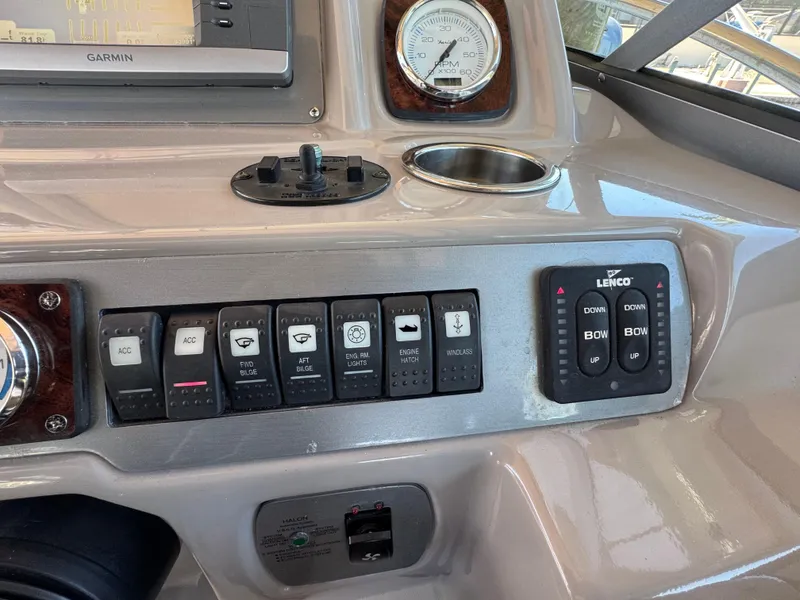 Slide: The Image of Control panel of a 2009 Chaparral Signature 290 boat with switches and gauges. - 11