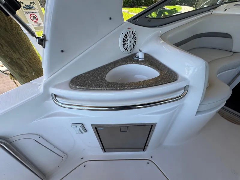 Slide: The Image of 2009 Chaparral Signature 290 boat interior with sink and seating area. - 17