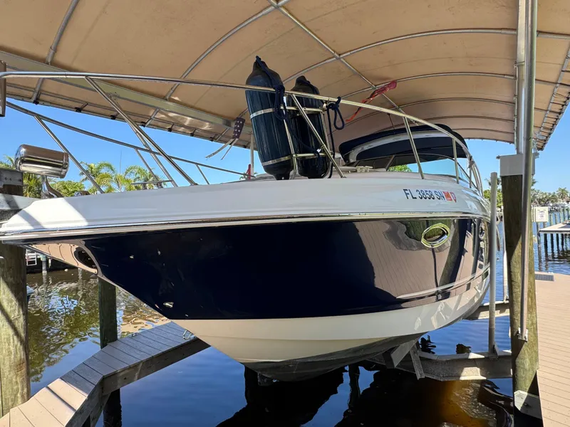 Slide: The Image of 2009 Chaparral Signature 290 boat docked under a canopy, side view. - 2