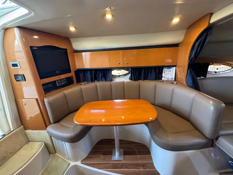 Slide: The Image of 2009 Chaparral Signature 290 interior with cozy seating and wooden table. - 21