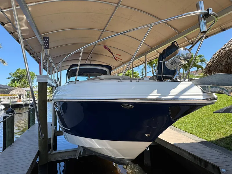 Slide: The Image of 2009 Chaparral Signature 290 boat docked under a canopy in a sunny marina. - 3