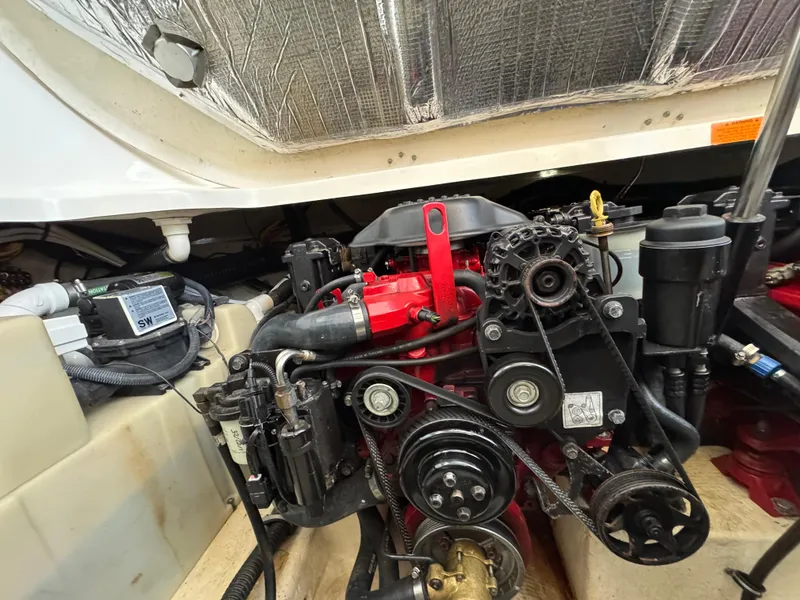 Slide: The Image of Engine compartment of a 2009 Chaparral Signature 290 boat, showcasing mechanical components. - 32