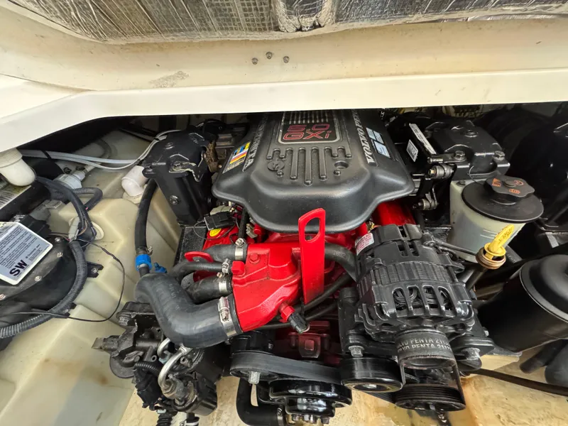 Slide: The Image of Engine compartment of a 2009 Chaparral Signature 290 boat, featuring a powerful engine setup. - 33