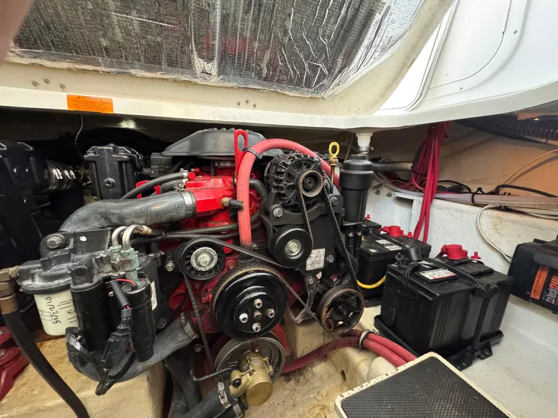 Slide: The Image of Engine compartment of a 2009 Chaparral Signature 290 boat, featuring visible components and wiring. - 34