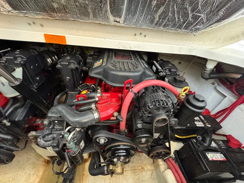 Slide: The Image of Engine compartment of a 2009 Chaparral Signature 290 boat, showcasing mechanical components. - 35