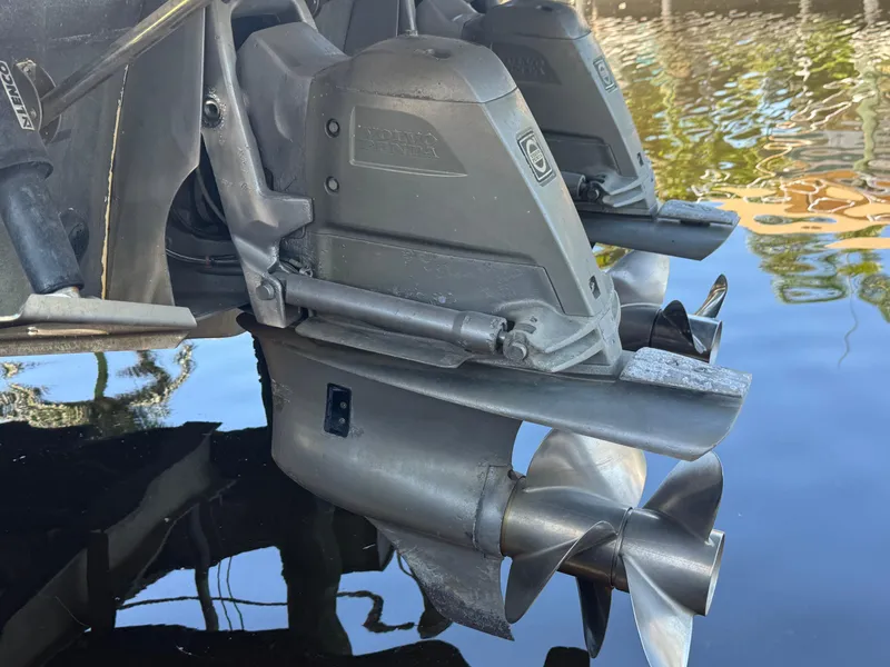 Slide: The Image of 2009 Chaparral Signature 290 boat propellers in water, showcasing dual outdrive system. - 36