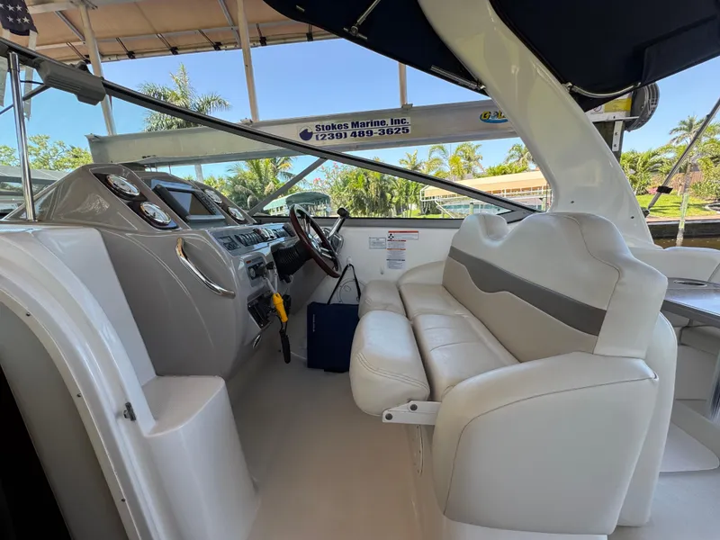 Slide: The Image of 2009 Chaparral Signature 290 boat interior with white seating and modern dashboard. - 5