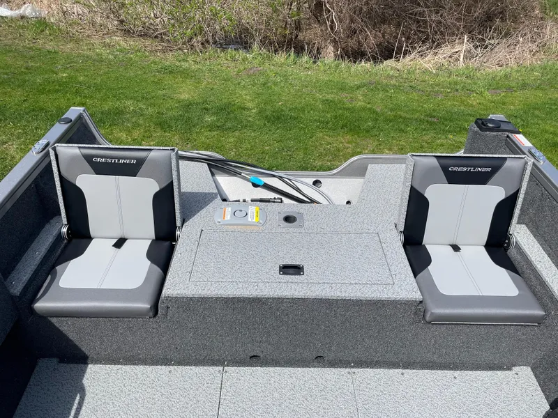 Slide: The Image of 2025 Crestliner 1750 Hawk SC boat interior with two gray seats and storage compartment. - 4