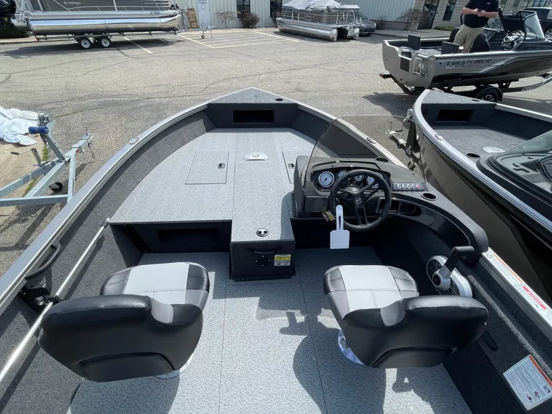 Slide: The Image of 2025 Crestliner 1750 Hawk SC boat interior with dual seats and steering console. - 8