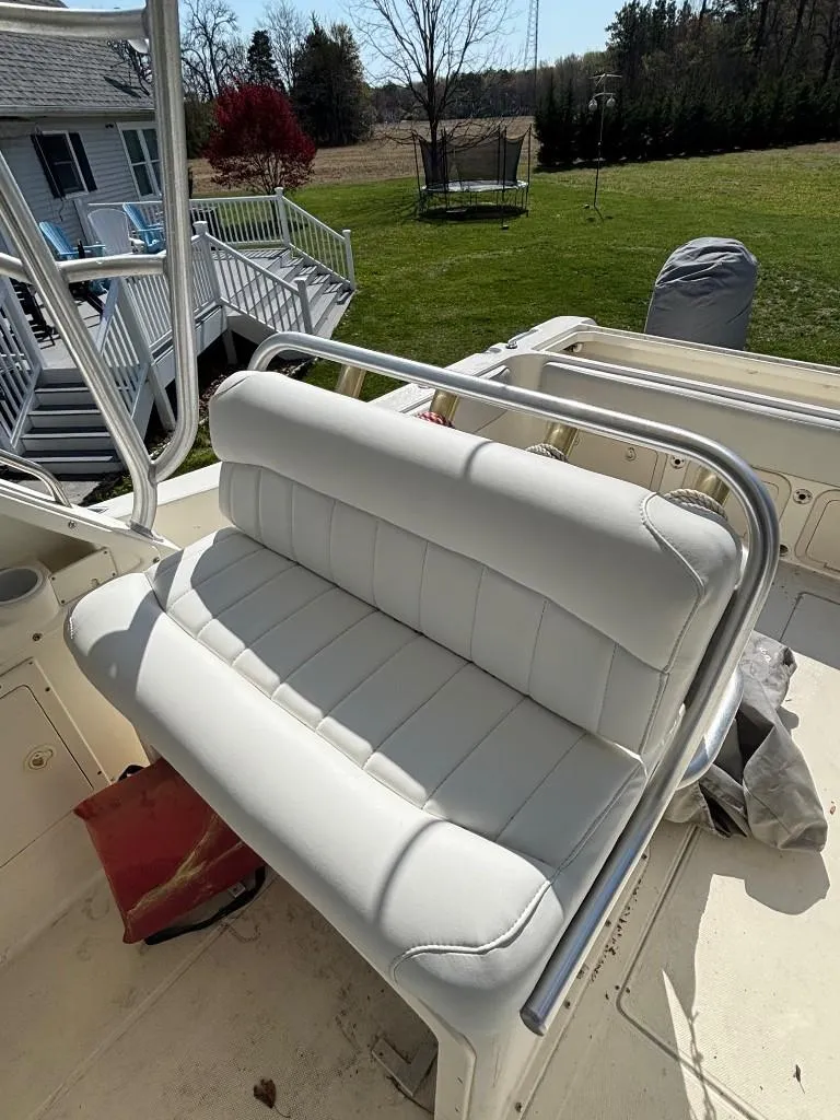 Slide: The Image of 2001 World Cat 266 SC boat with white cushioned seating and stainless steel frame. - 10