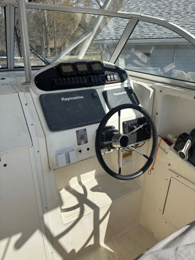 Slide: The Image of 2001 World Cat 266 SC boat cockpit with steering wheel and navigation equipment. - 3