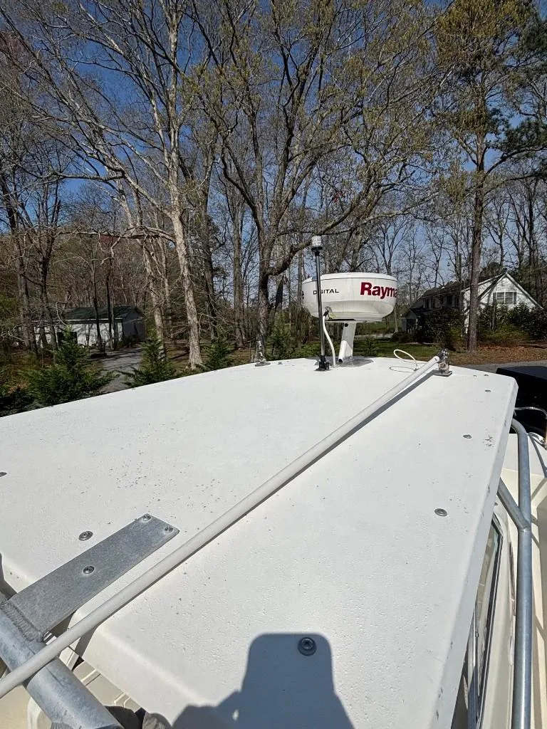 Slide: The Image of 2001 World Cat 266 SC boat roof with radar, surrounded by trees. - 6