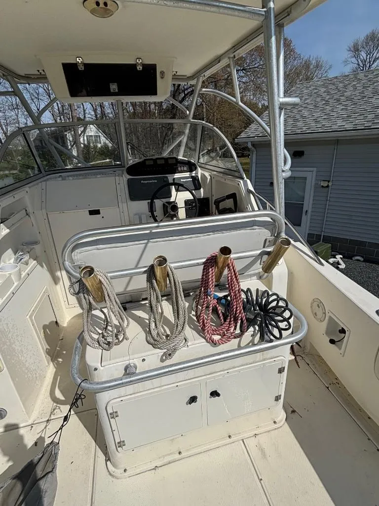 Slide: The Image of 2001 World Cat 266 SC boat interior with ropes and steering console. - 9
