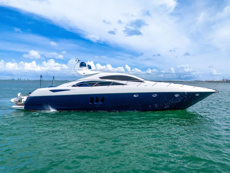 Slide: The Image of 2006 Sunseeker Predator 72 yacht cruising on open water under a clear blue sky. - 0