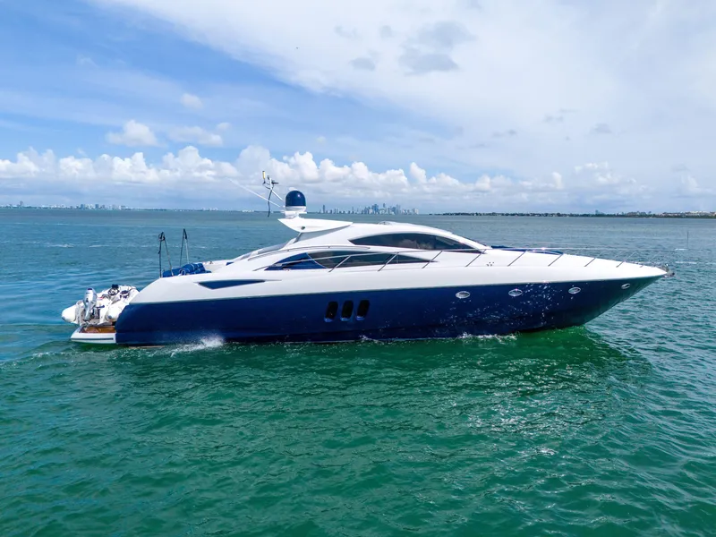 Slide: The Image of 2006 Sunseeker Predator 72 yacht cruising on open water under a clear sky. - 1