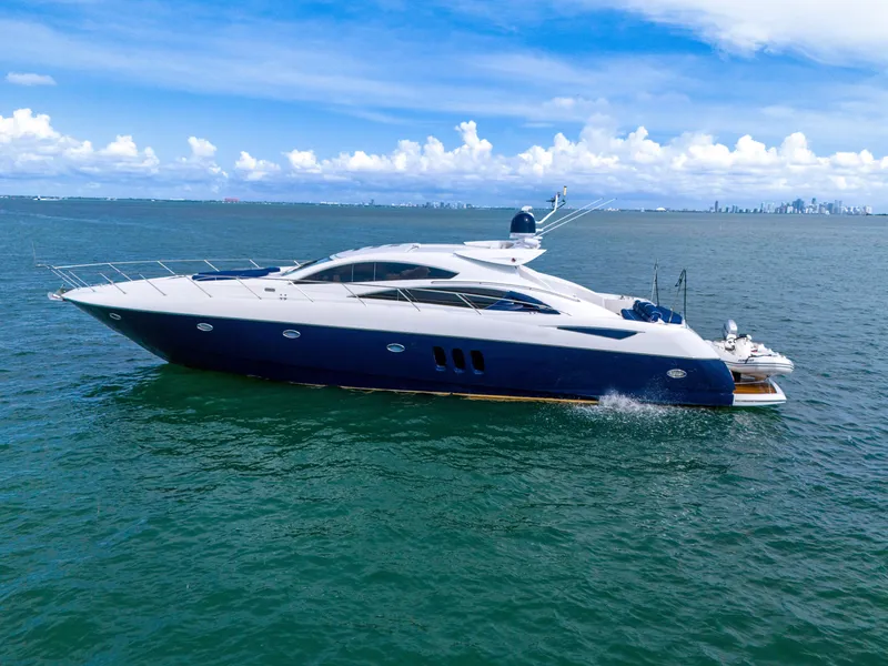 Slide: The Image of 2006 Sunseeker Predator 72 yacht cruising on open water under a clear blue sky. - 10