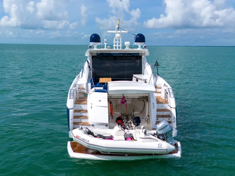 Slide: The Image of Sunseeker Predator 72 yacht, 2006 model, with tender, on open sea under cloudy sky. - 15