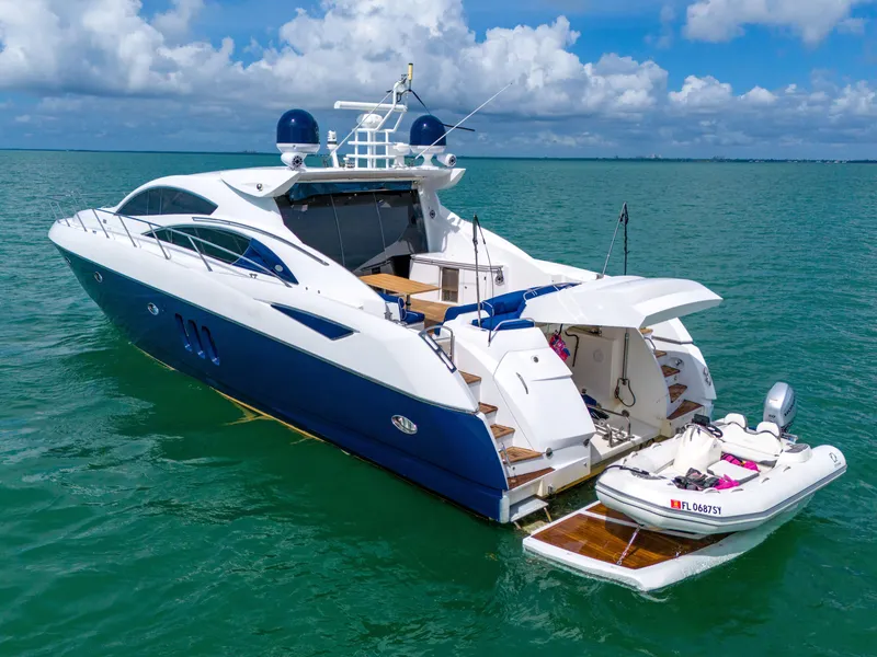 Slide: The Image of 2006 Sunseeker Predator 72 yacht on water with small boat attached. - 16