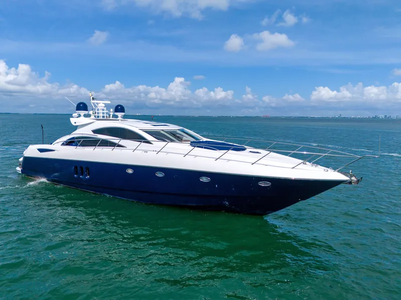 Slide: The Image of Sunseeker Predator 72 yacht, 2006 model, cruising on open water under a clear blue sky. - 2