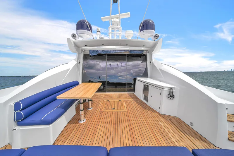 Slide: The Image of Luxurious 2006 Sunseeker Predator 72 yacht deck with blue seating and wooden flooring. - 27