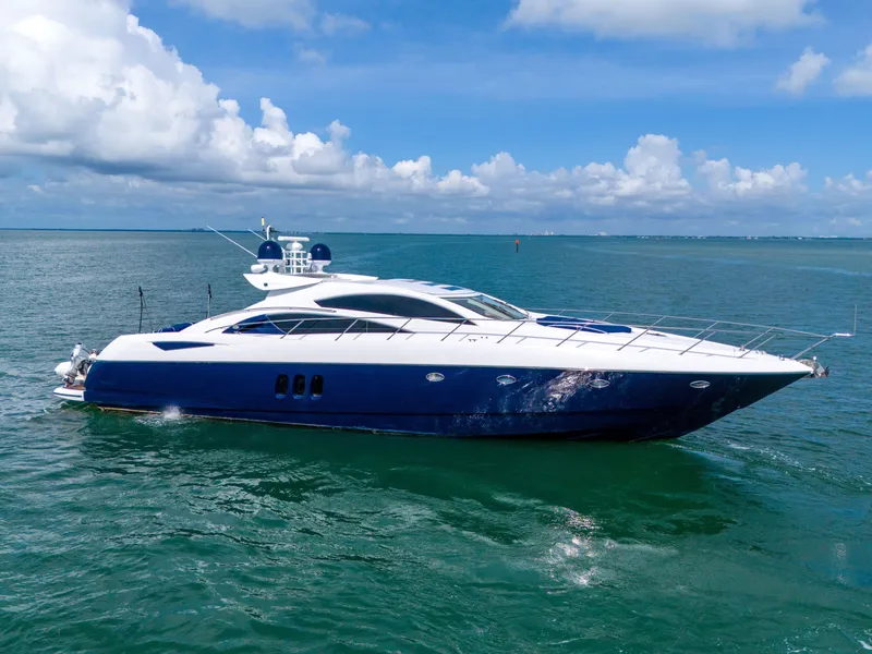 Slide: The Image of 2006 Sunseeker Predator 72 yacht cruising on open water under a clear blue sky. - 3
