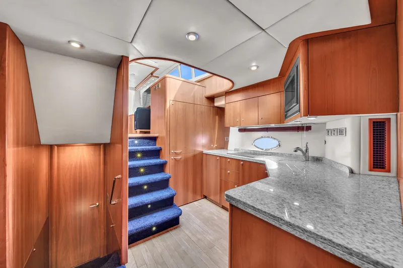 Slide: The Image of Luxurious interior of 2006 Sunseeker Predator 72 yacht with modern kitchen and wooden cabinetry. - 37
