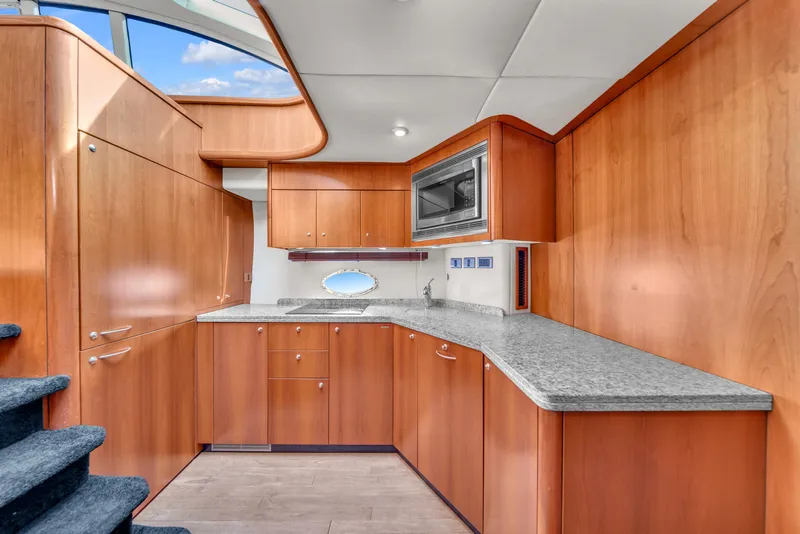 Slide: The Image of Luxurious kitchen interior of 2006 Sunseeker Predator 72 yacht with wooden cabinetry. - 38