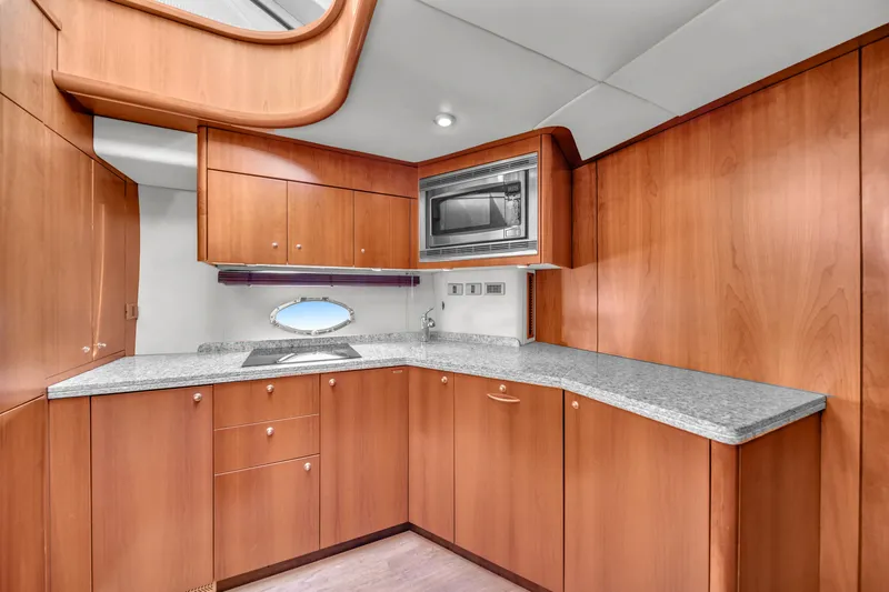 Slide: The Image of Luxurious kitchen interior of 2006 Sunseeker Predator 72 yacht with wood cabinetry and modern appliances. - 39
