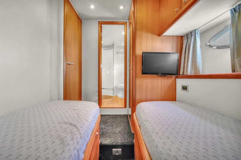 Slide: The Image of Twin cabin interior of 2006 Sunseeker Predator 72 yacht with TV and wooden finishes. - 42