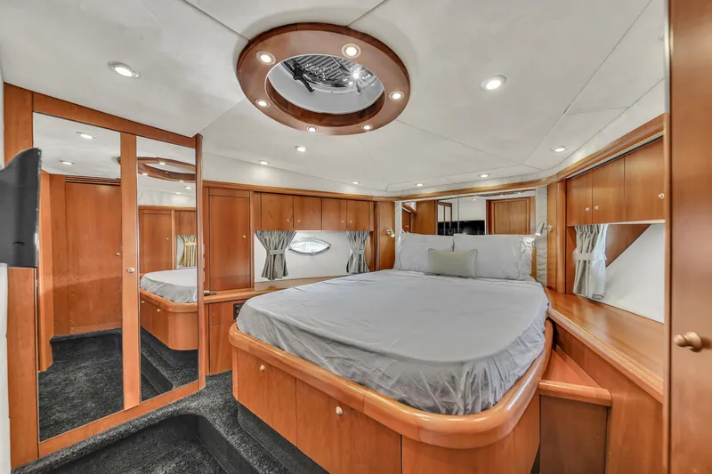 Slide: The Image of Luxurious bedroom interior of 2006 Sunseeker Predator 72 yacht with wood paneling and mirrors. - 45