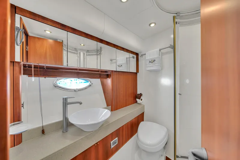 Slide: The Image of Luxurious bathroom in 2006 Sunseeker Predator 72 yacht with modern fixtures and wood accents. - 46