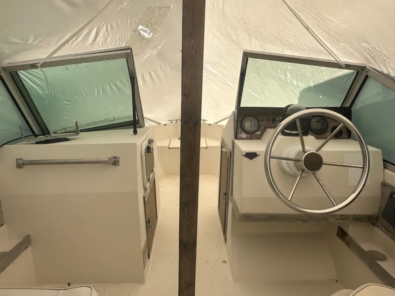 Slide: The Image of 1983 Grady-White Tournament 170 boat interior with steering wheel and dashboard. - 2