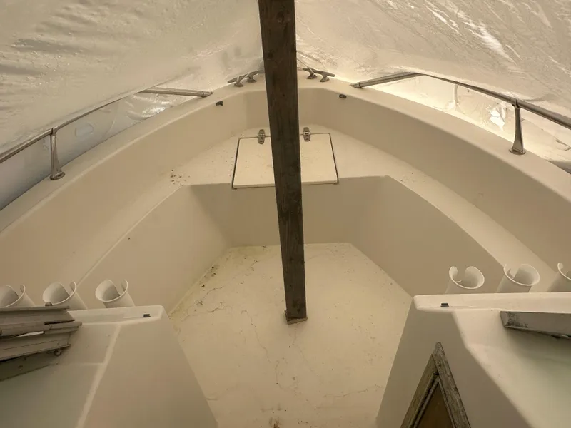 Slide: The Image of 1983 Grady-White Tournament 170 boat interior under cover, showing seating and storage areas. - 3