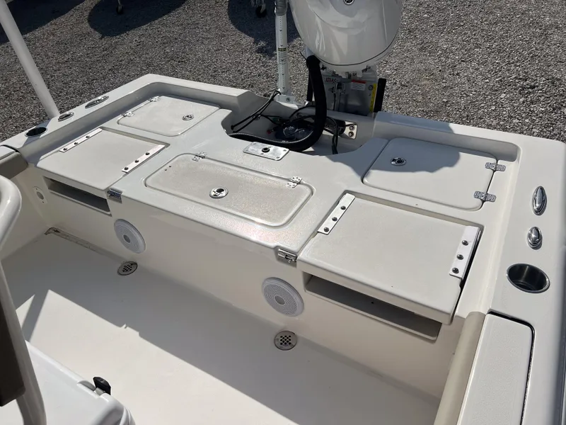 Slide: The Image of 2025 Key West 250 Bay Reef boat deck with storage compartments and speakers. - 11