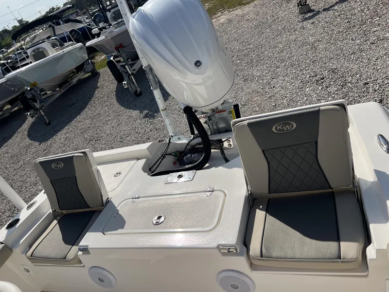 Slide: The Image of 2025 Key West 250 Bay Reef boat with cushioned seating and outboard motor. - 12