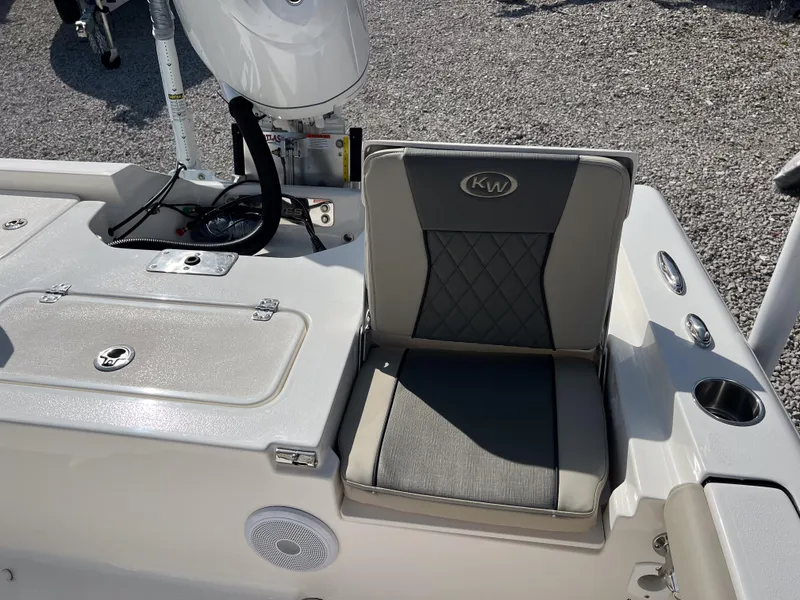Slide: The Image of 2025 Key West 250 Bay Reef boat seat with gray upholstery and storage compartment. - 13