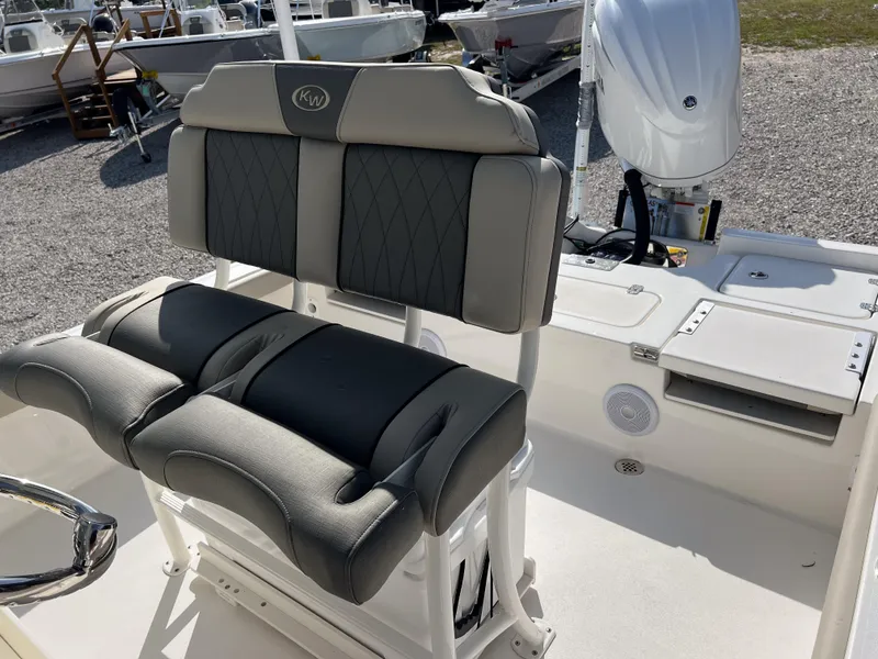 Slide: The Image of 2025 Key West 250 Bay Reef boat interior with cushioned seating and modern design. - 15