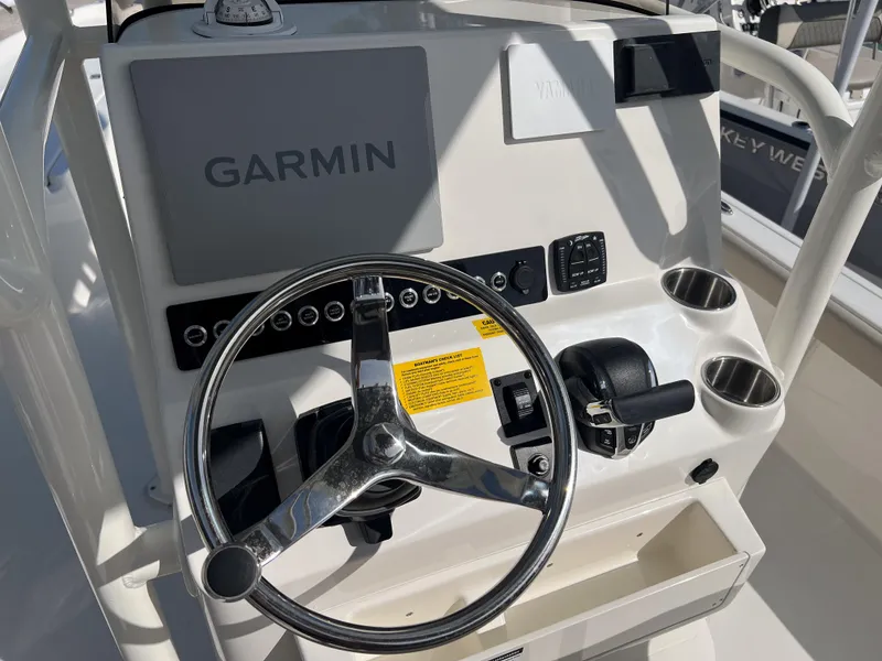 Slide: The Image of Steering console of 2025 Key West 250 Bay Reef boat with Garmin navigation system. - 19