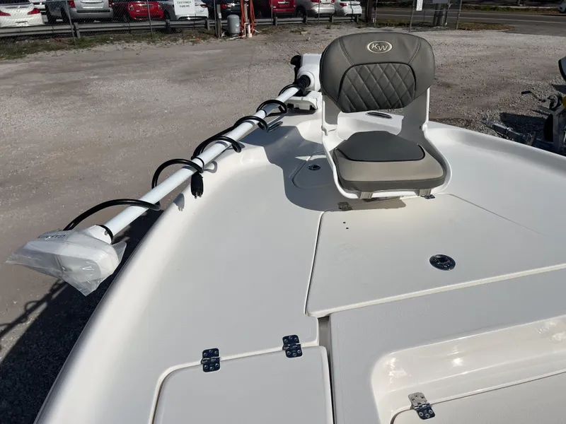 Slide: The Image of 2025 Key West 250 Bay Reef boat with cushioned seating and mounted equipment. - 23
