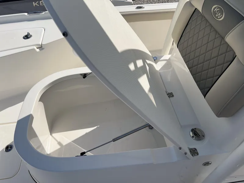 Slide: The Image of 2025 Key West 250 Bay Reef boat storage compartment with cushioned seat. - 26