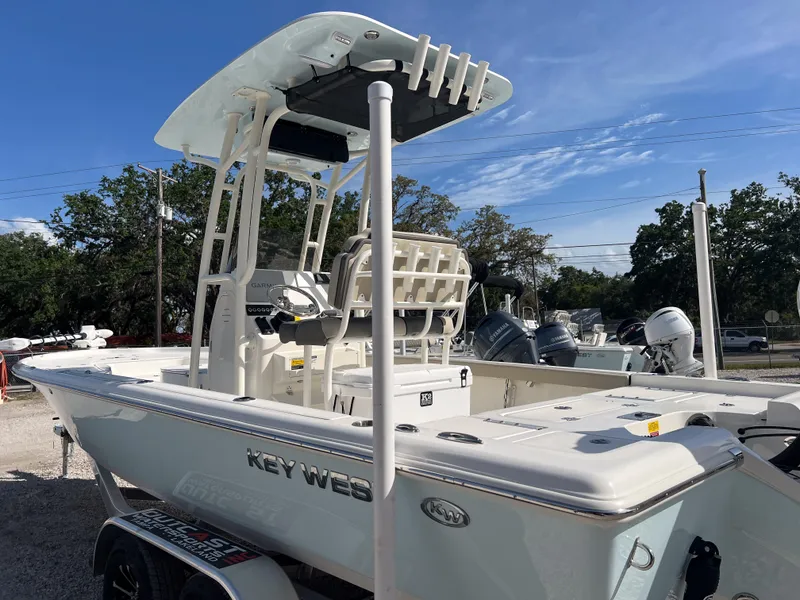 Slide: The Image of 2025 Key West 250 Bay Reef boat with T-top, parked outdoors. - 3