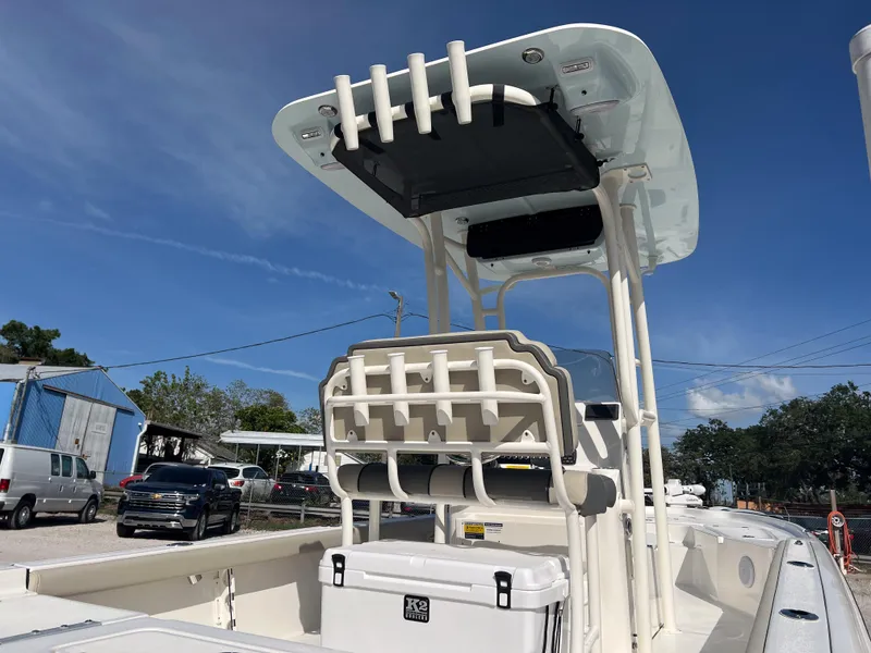 Slide: The Image of 2025 Key West 250 Bay Reef boat with T-top and rod holders, docked outdoors. - 5