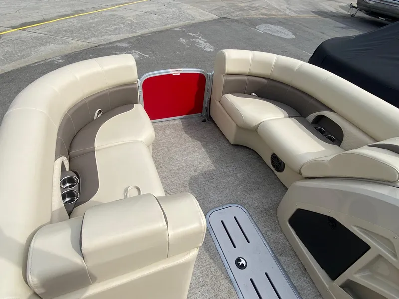 Slide: The Image of Luxurious seating on 2022 Premier 210 Sunsation RL pontoon boat, featuring beige upholstery. - 10