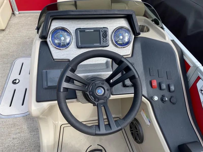 Slide: The Image of 2022 Premier 210 Sunsation RL boat dashboard with steering wheel and control panel. - 12