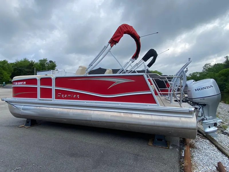 Slide: The Image of 2022 Premier 210 Sunsation RL pontoon boat with red exterior and Honda outboard motor. - 3