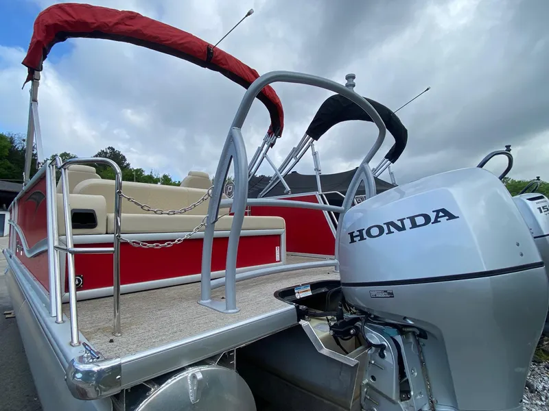 Slide: The Image of 2022 Premier 210 Sunsation RL pontoon boat with Honda outboard motor, red and beige design. - 4