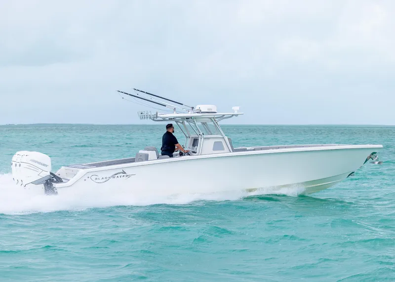 Slide: The Image of 2021 Blackwater 36 Sport boat cruising on turquoise ocean waters. - 0